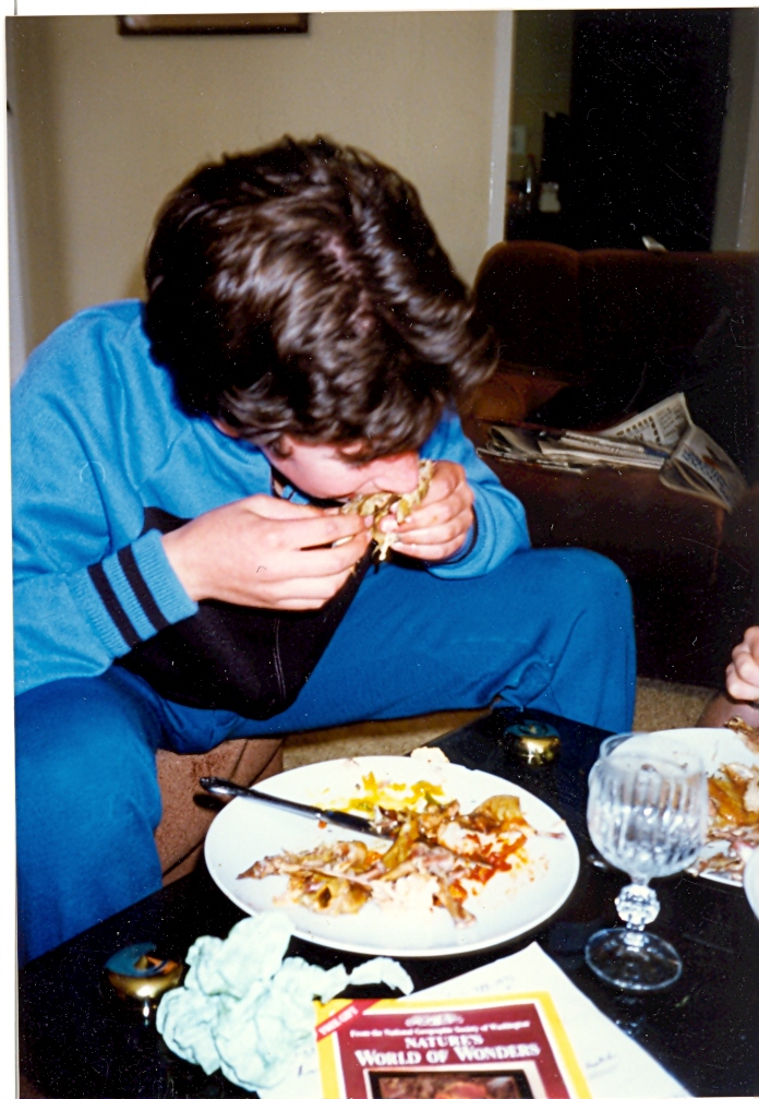 Enjoying his food in the lounge watching TV